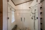 Main floor bathroom offers beautiful stone & tile with a walk in shower